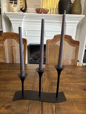 Black metal modern candle holder holds three candles